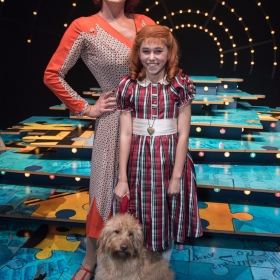 Craig Revel Horwood (Miss Hannigan), Ruby Stokes (Annie) and Amber (Sandy) - Annie at the Piccadilly Theatre - Photo credit Craig Sugden
